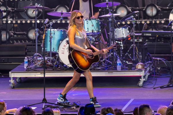 Country artist Alana Springsteen onstage with her guitar