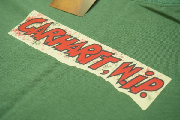 Orange Carhartt W.I.P. logo on green fabric