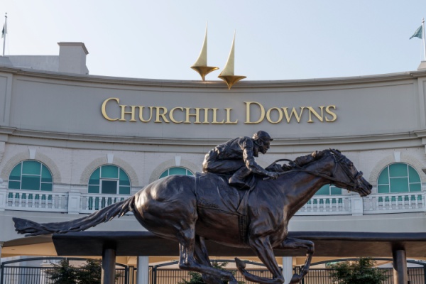 Statue of jockey on horse in front of Churchill Downs racetrack