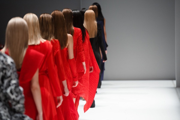 Models single file leaving runway wearing red