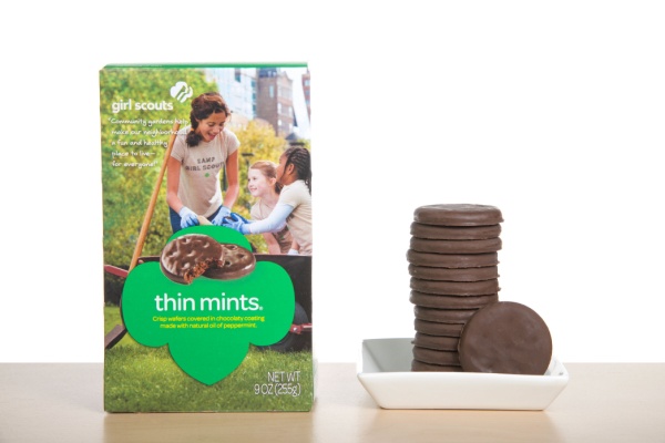Box next to stack of Girl Scouts Thin Mint Cookies