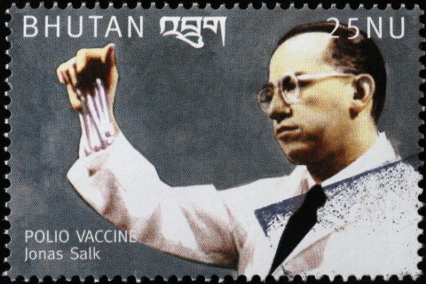 Jonas Salk holding test tubes on Bhutan postage stamp