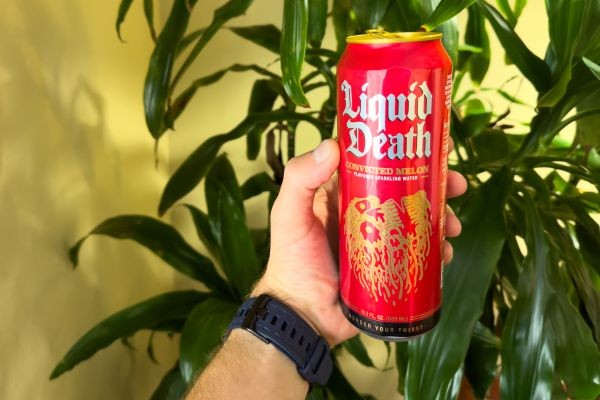 Male hand holding a can of Liquid Death sparkling