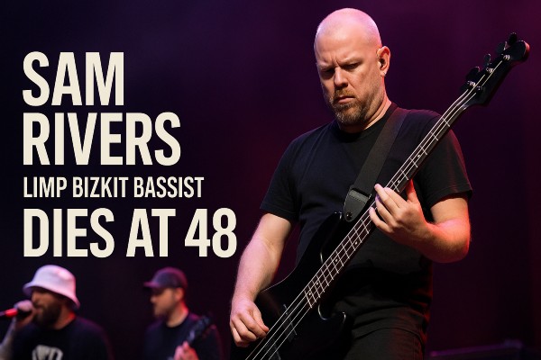 Sam Rivers from Limp Bizkit playing bass guitar on stage