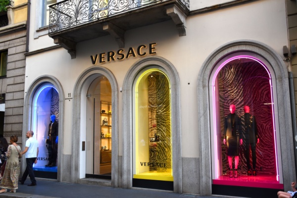 Exterior windows of Versace store in Milan Italy, lit up in rainbow hues
