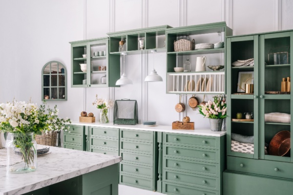White kitchen with sage green cabinetry