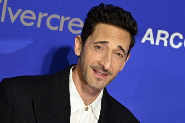 A photograph of actor Adrien Brody on the red carpet at the Palm Springs Film Festival.