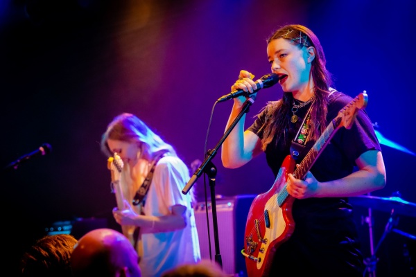 A photo of indie rock band Wet Leg performing at a concert.